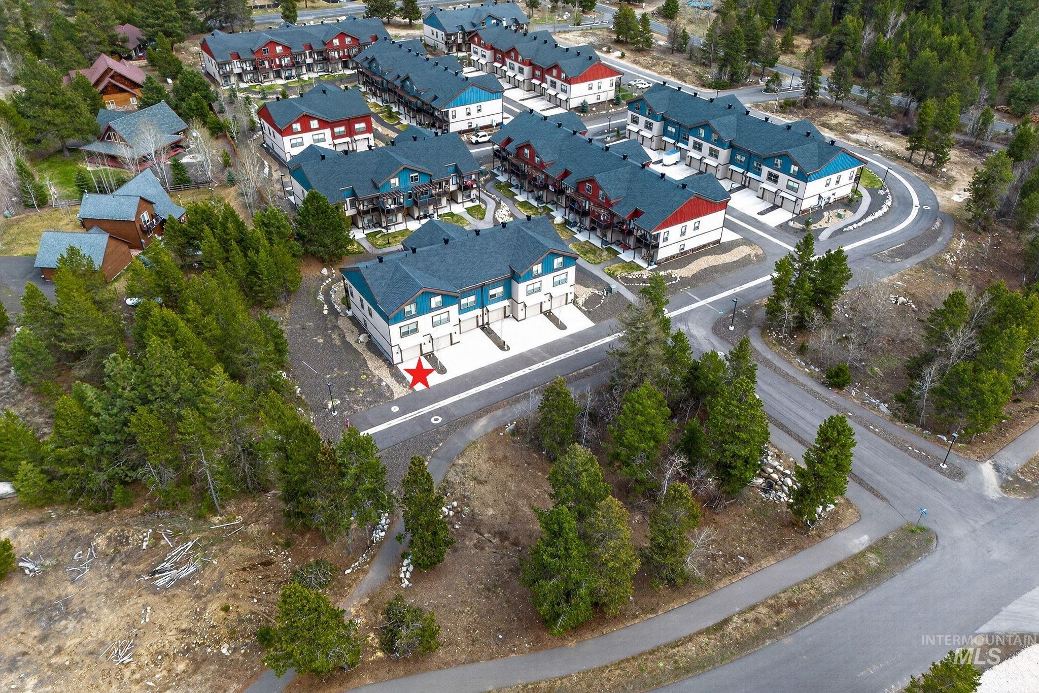Modern townhome community featuring multi-level residences with contrasting siding and dark-pitched roofs