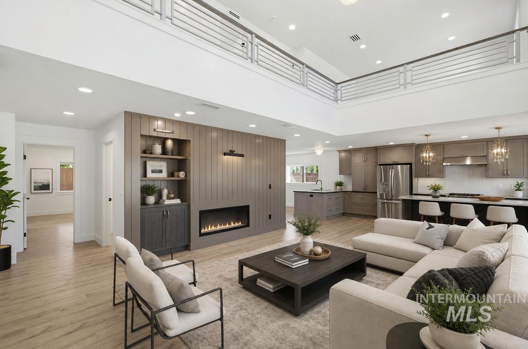 Open-concept living space featuring high ceilings and wood-finish flooring