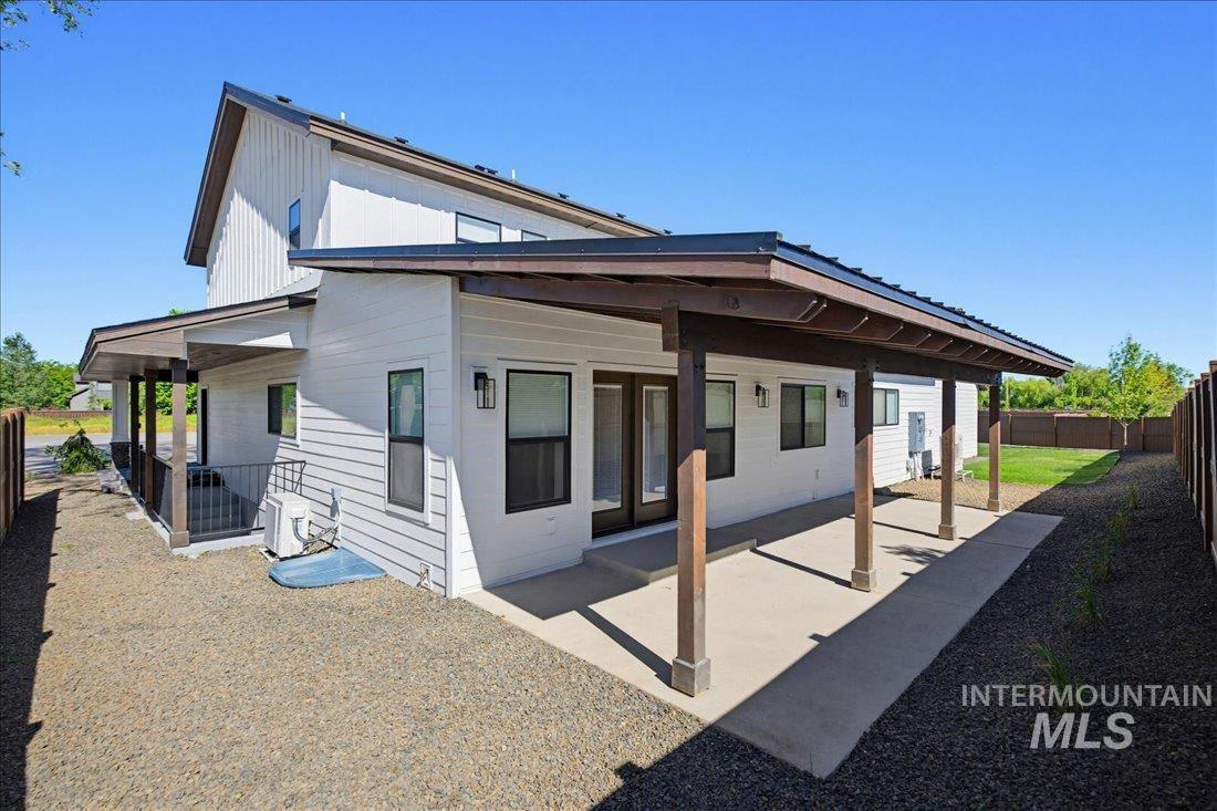 Contemporary exterior featuring white horizontal siding and a dark trim roofline