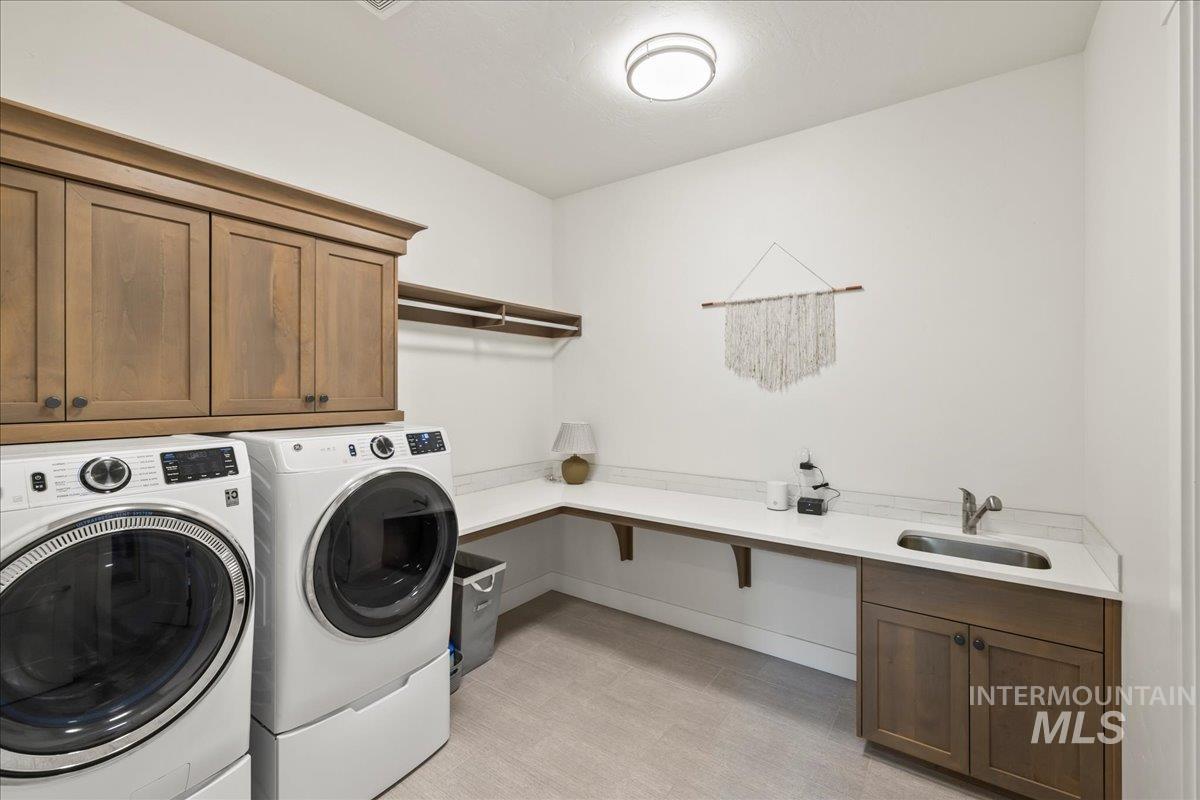 Laundry room featuring washer and dryer and cabinet space