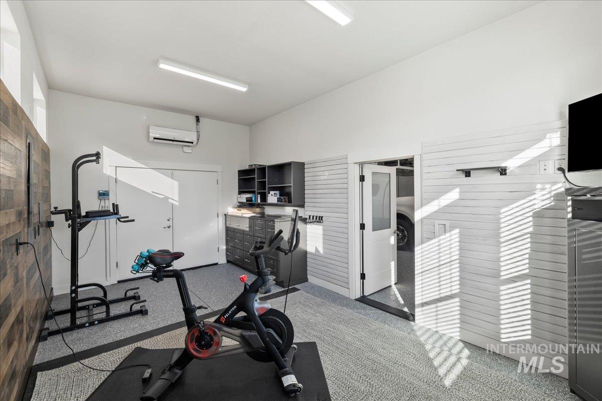 Workout area featuring an AC wall unit