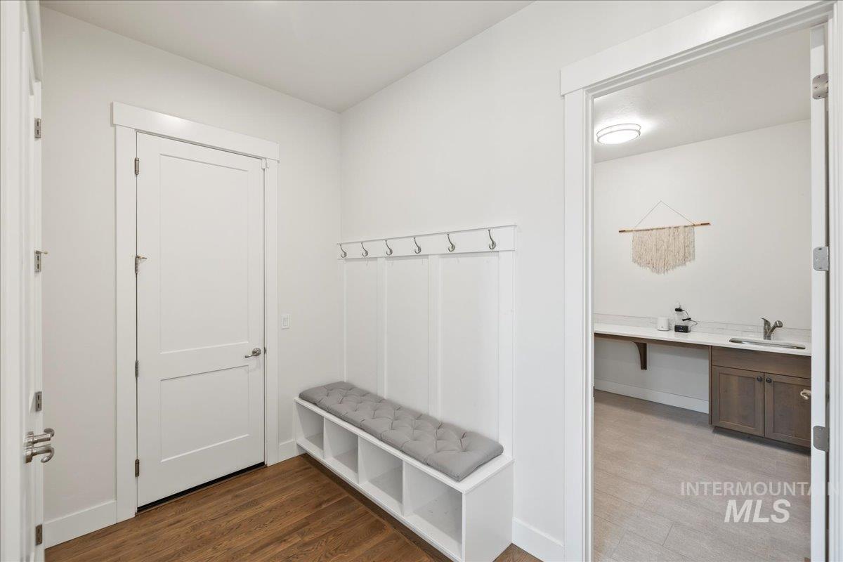Mudroom featuring a sink and wood finished floors