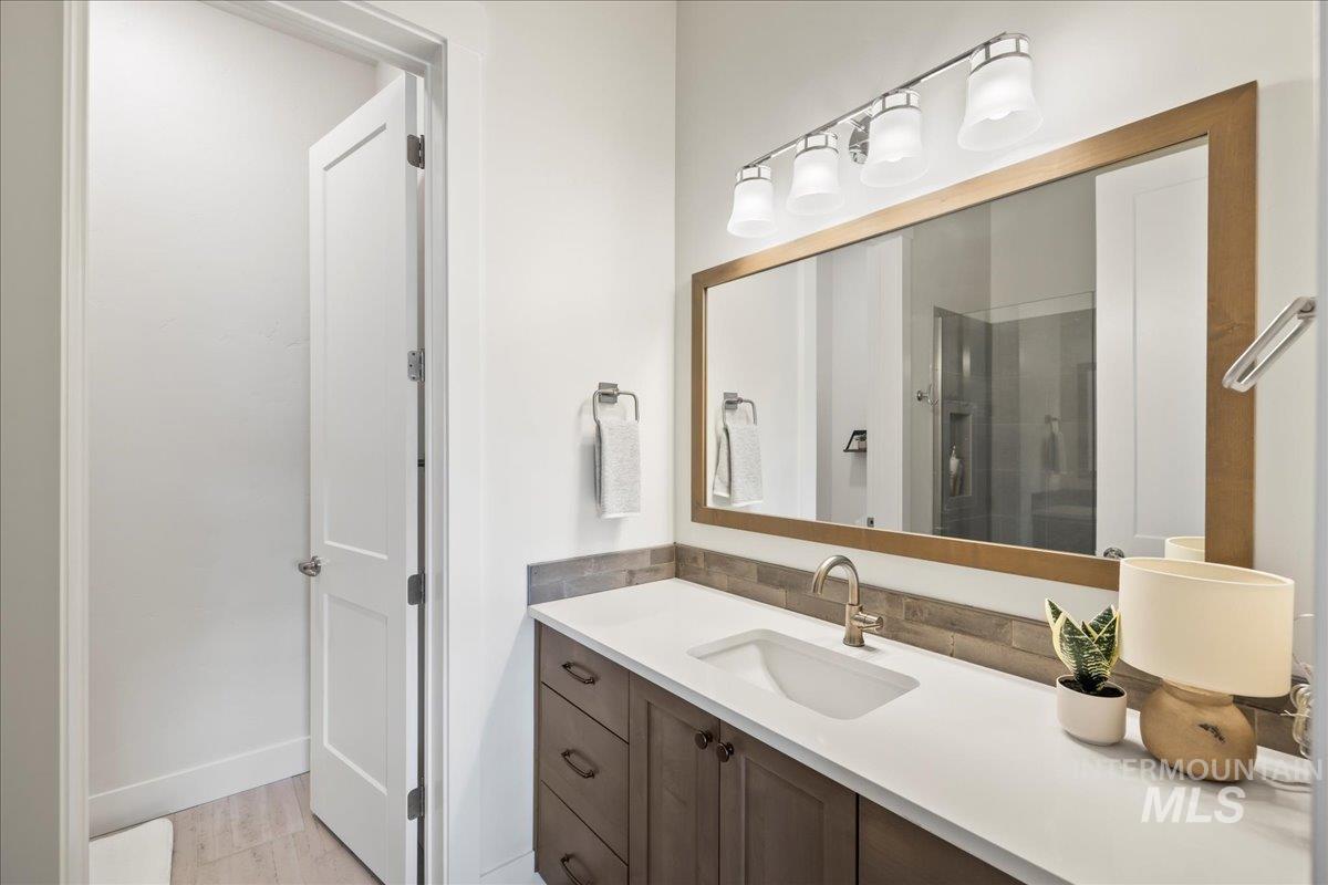 Full bath featuring vanity and a stall shower