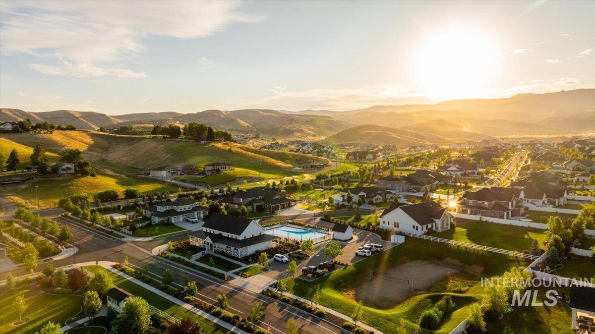 Aerial view of residential area featuring mountains and a pool area