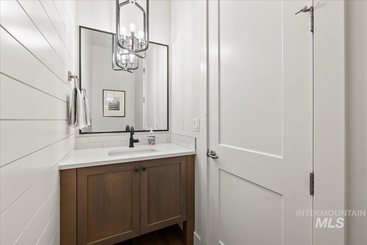 Bathroom featuring vanity and a chandelier