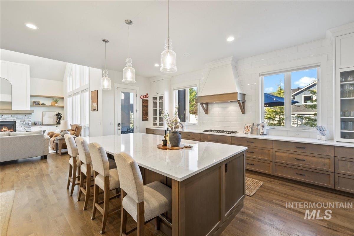 Kitchen with custom exhaust hood, backsplash, a kitchen island, healthy amount of natural light, and recessed lighting