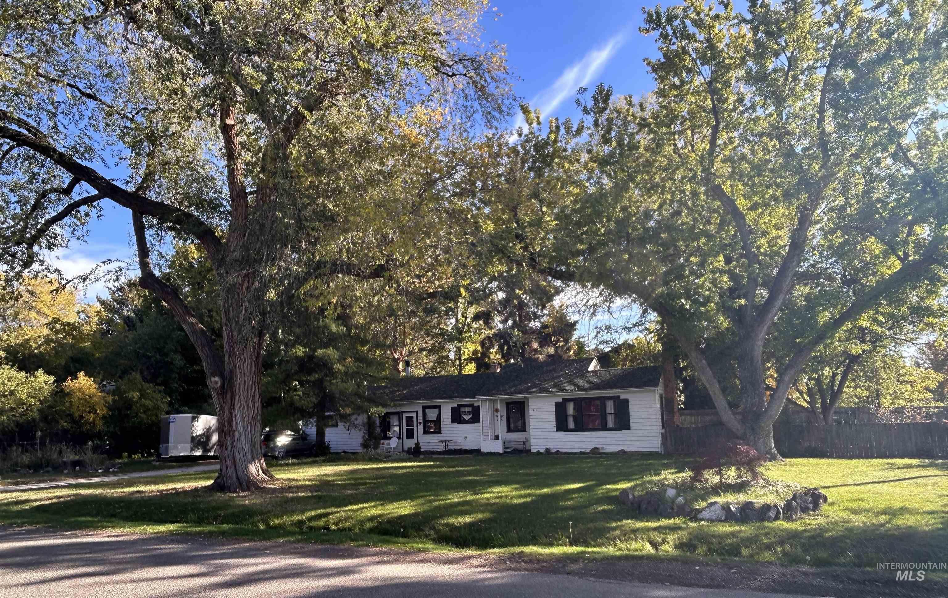Ranch-style home featuring view of scattered trees