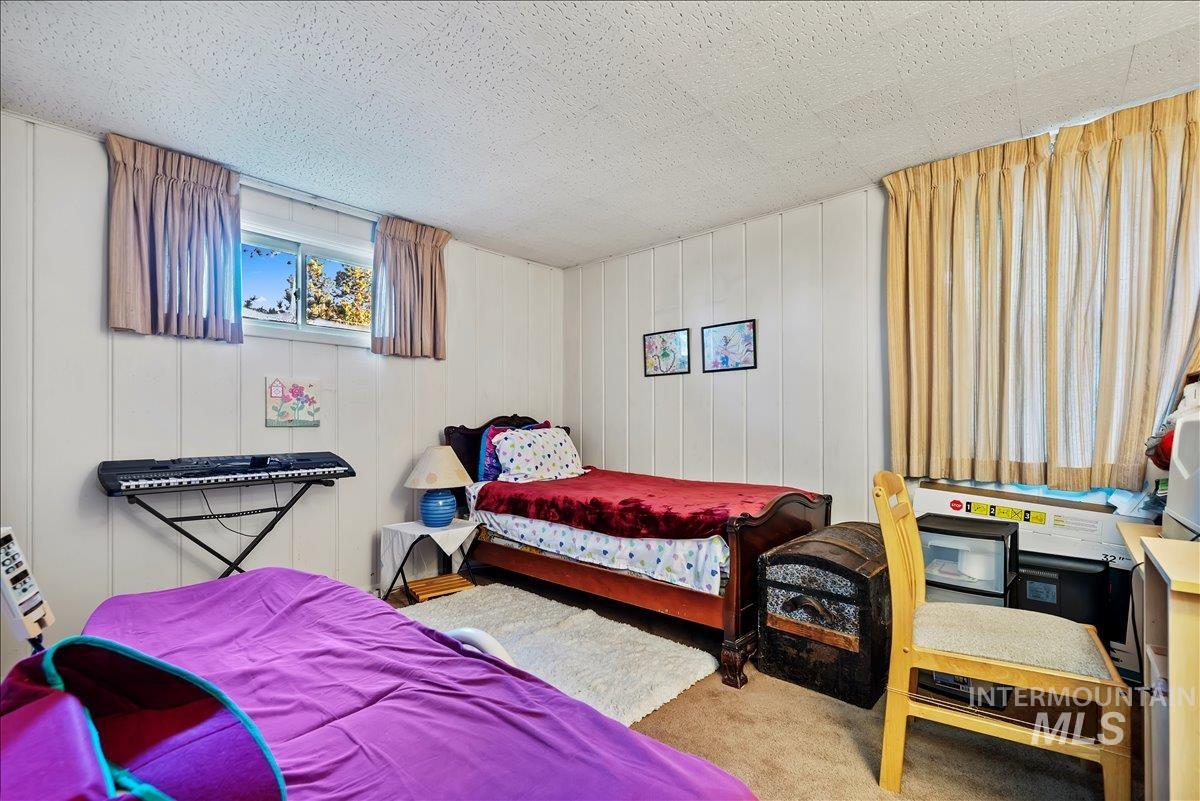 Carpeted bedroom with a textured ceiling