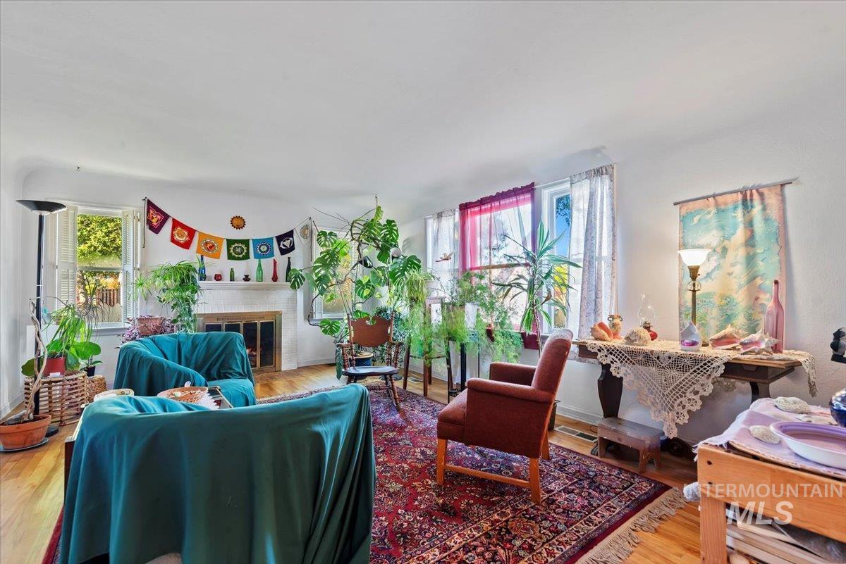 Living room with wood finished floors and a brick fireplace