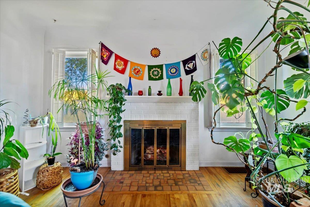 Living area with a brick fireplace and wood finished floors
