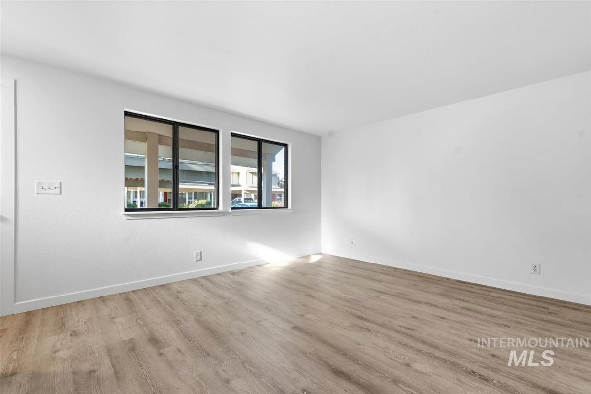 Bright room featuring light wood-finish flooring and white walls