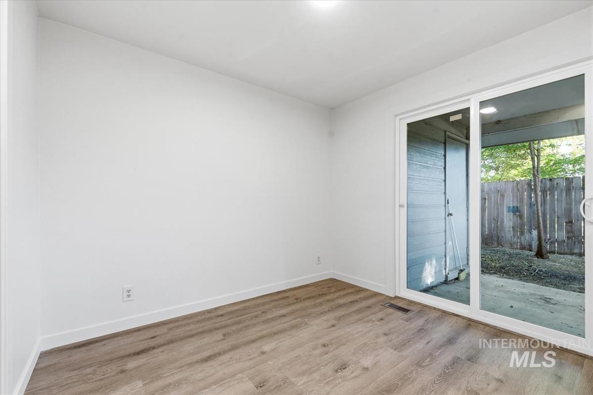 Neutral wall paint with wood-finish flooring