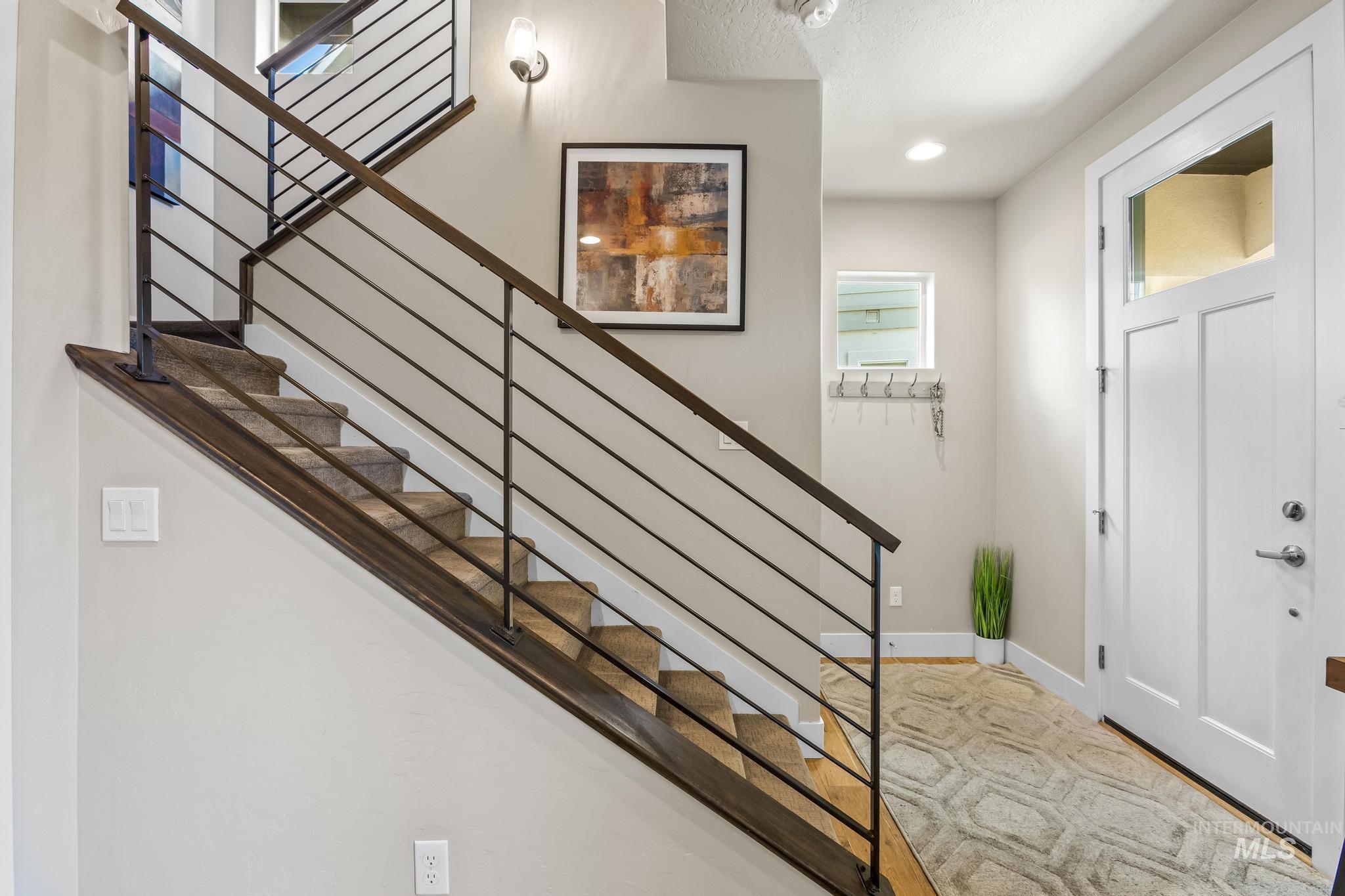 Foyer featuring stairs and baseboards