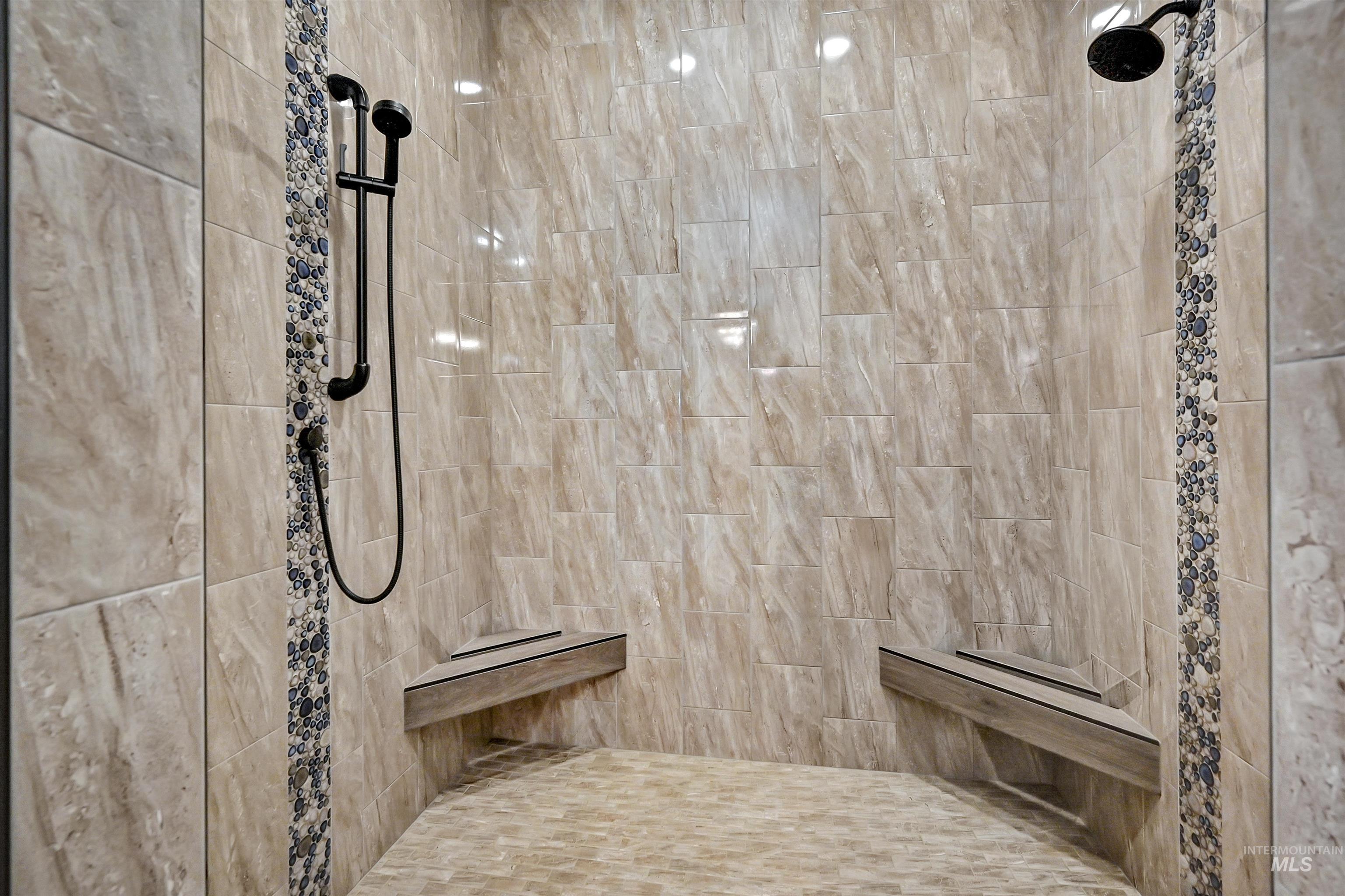 Walk-in shower with dual shower heads.