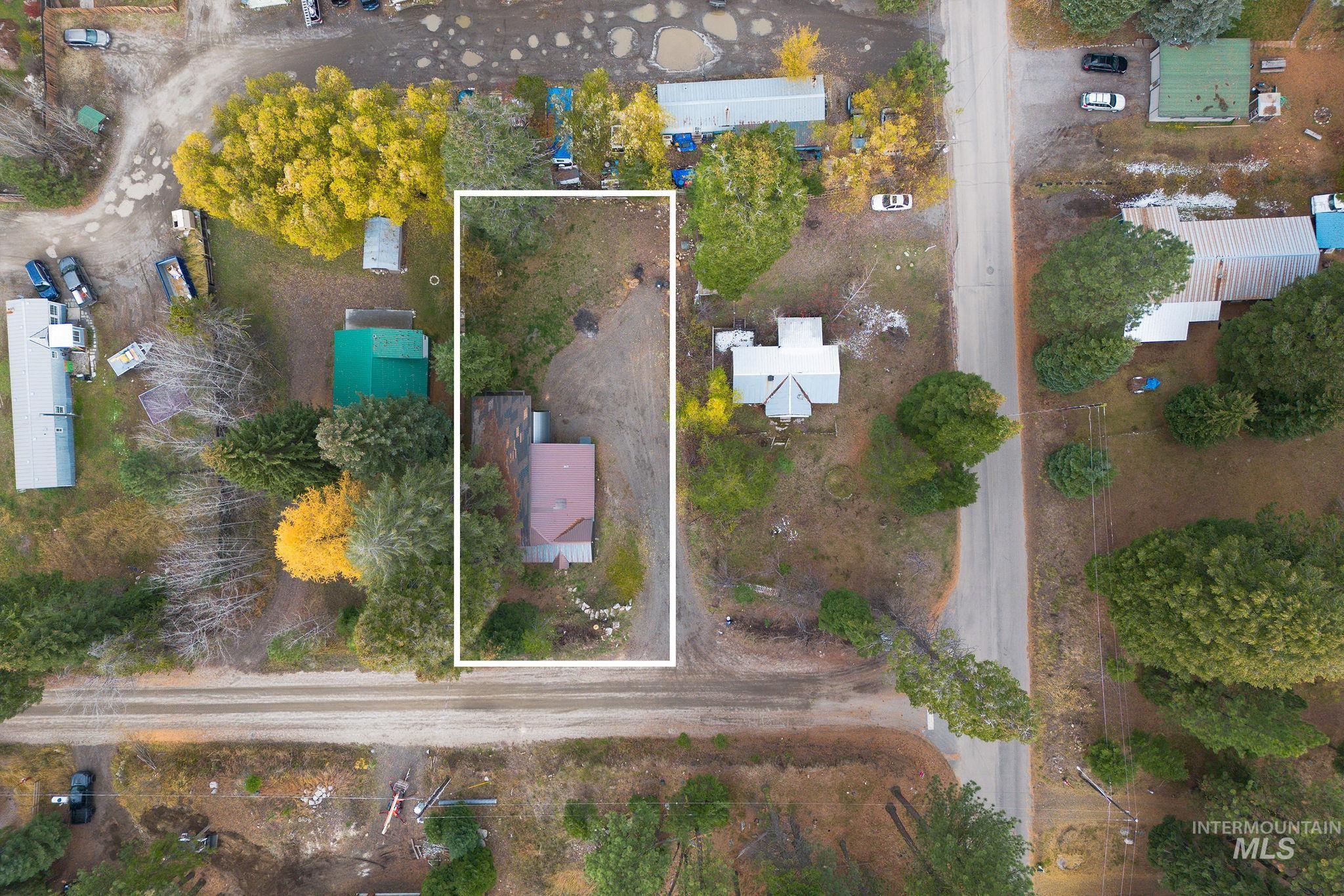 Aerial view of property and surrounding area featuring property boundaries highlighted