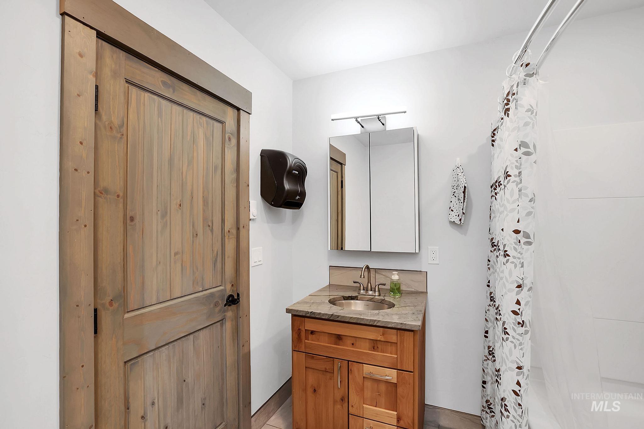 Bathroom featuring vanity and curtained shower
