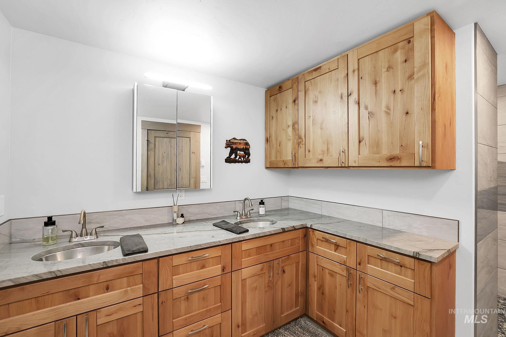 Kitchen with light stone countertops and a sink