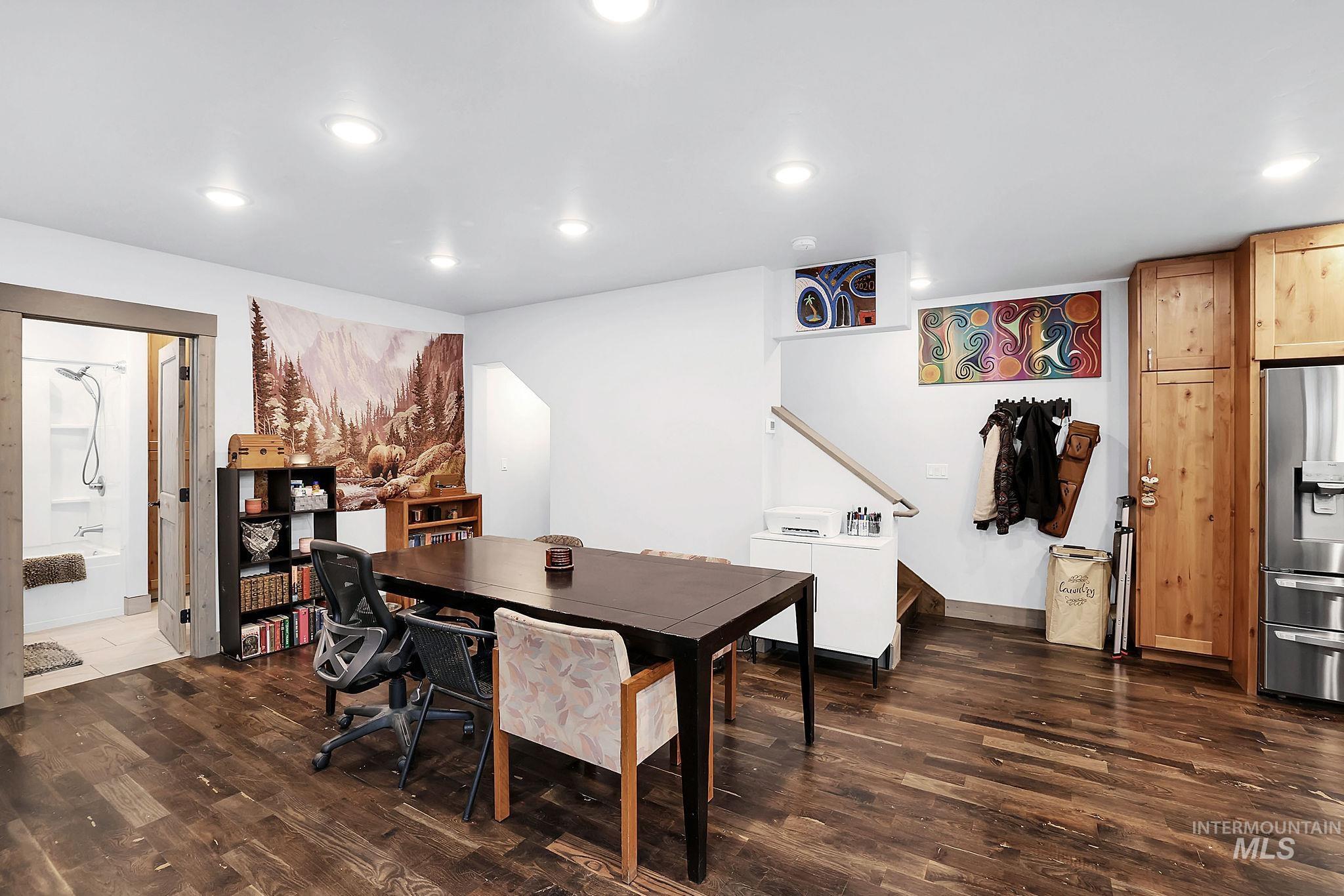 Office space with dark wood finished floors and recessed lighting