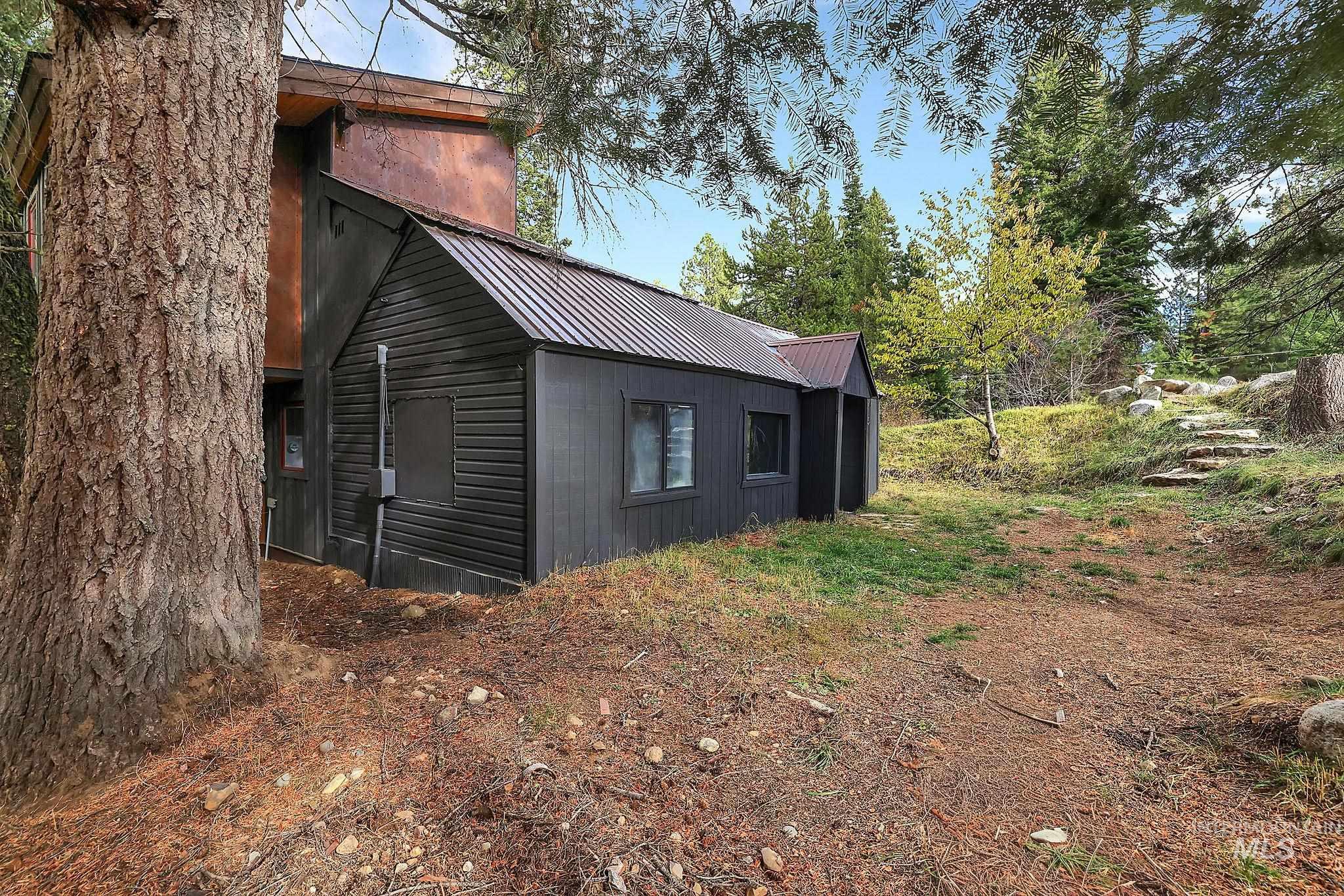 View of side of property featuring a metal roof