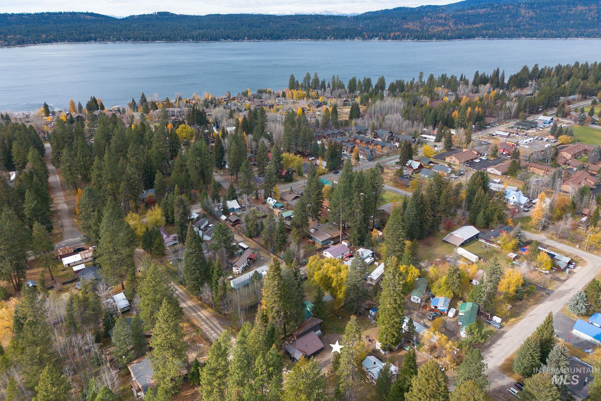 Aerial view of property and surrounding area with a large body of water and nearby suburban area