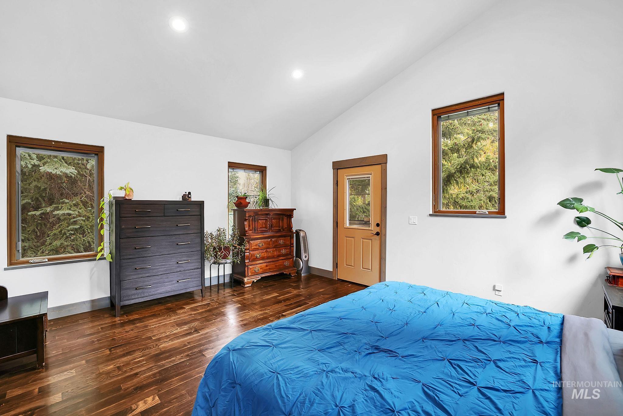 Bedroom featuring dark wood-style floors, recessed lighting, and lofted ceiling