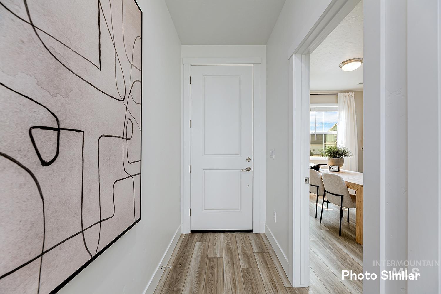 Doorway to outside featuring wood finished floors and baseboards