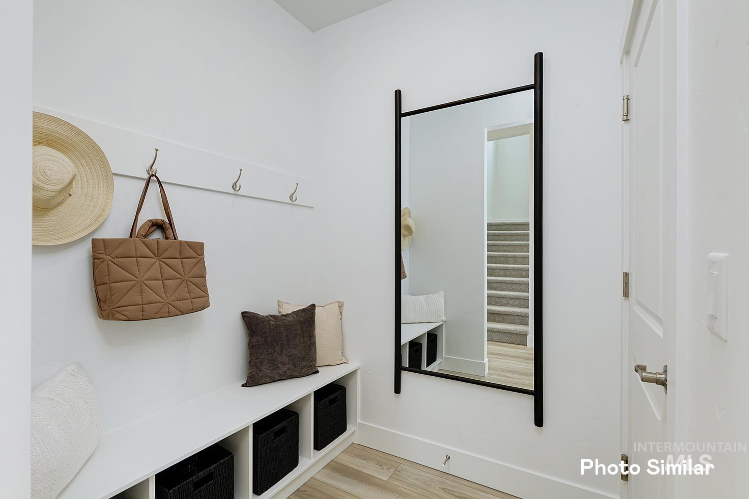 Mudroom with light wood finished floors and baseboards