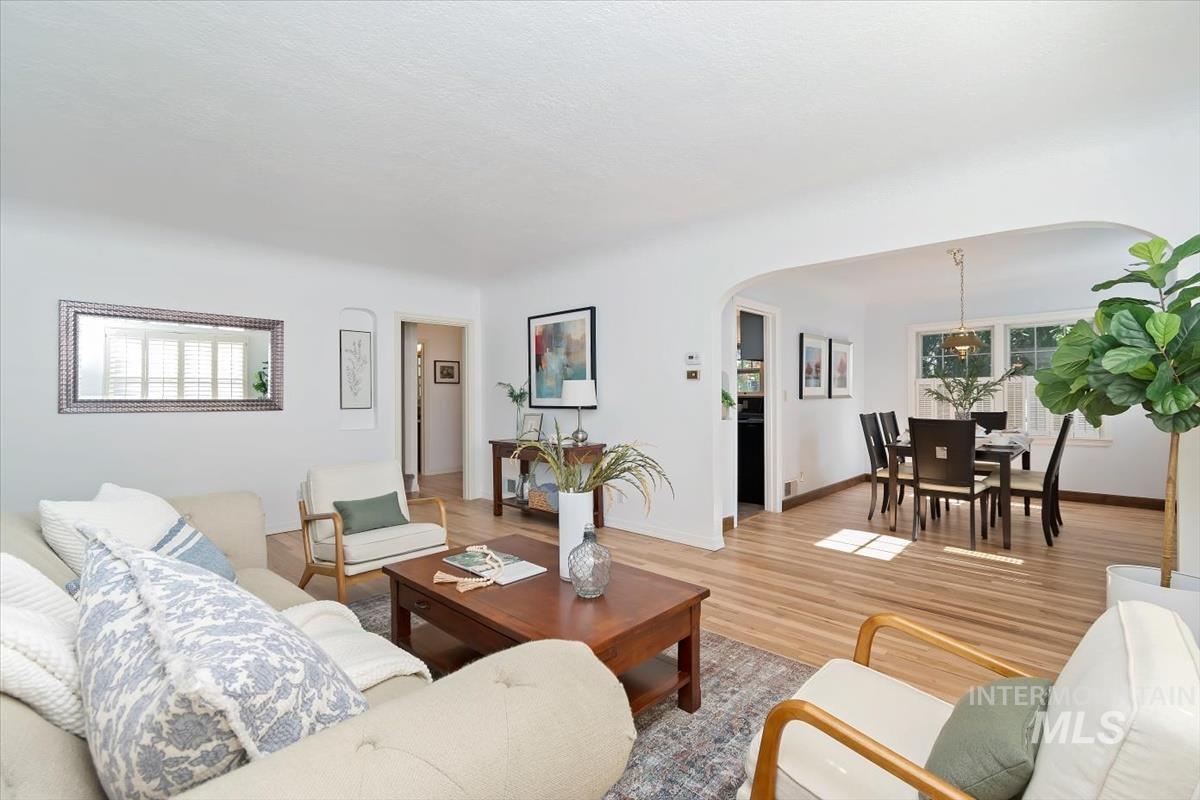Living area with wood finished floors and arched walkways