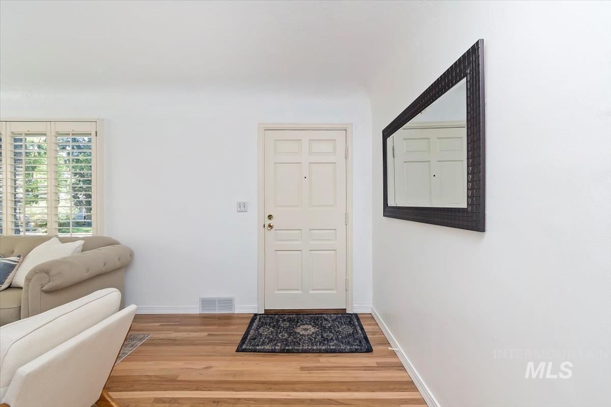 Entrance foyer with wood finished floors
