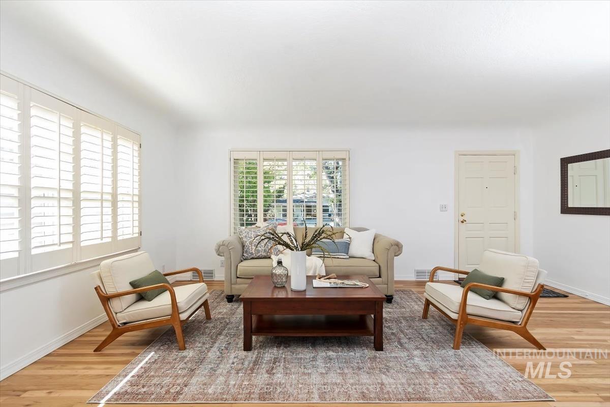 Living room featuring light wood-style flooring and baseboards
