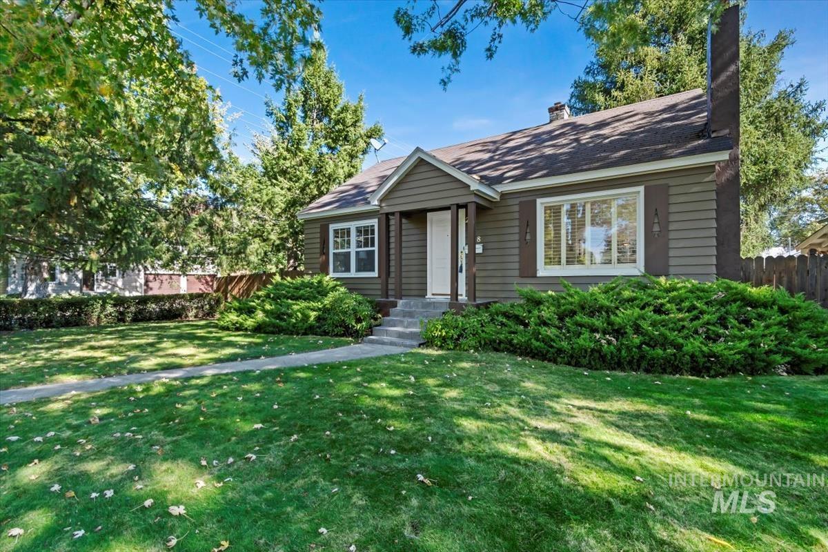 View of front of home featuring a chimney