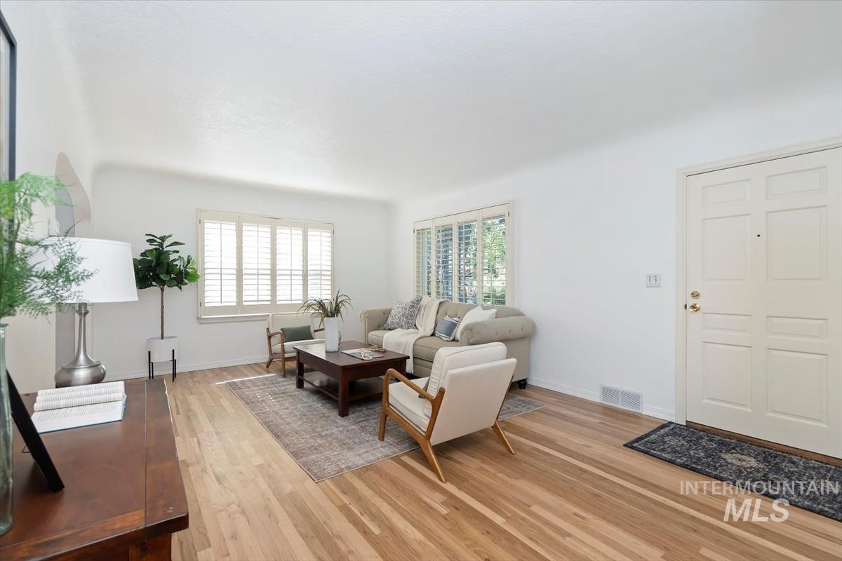Living room featuring healthy amount of natural light and light wood finished floors