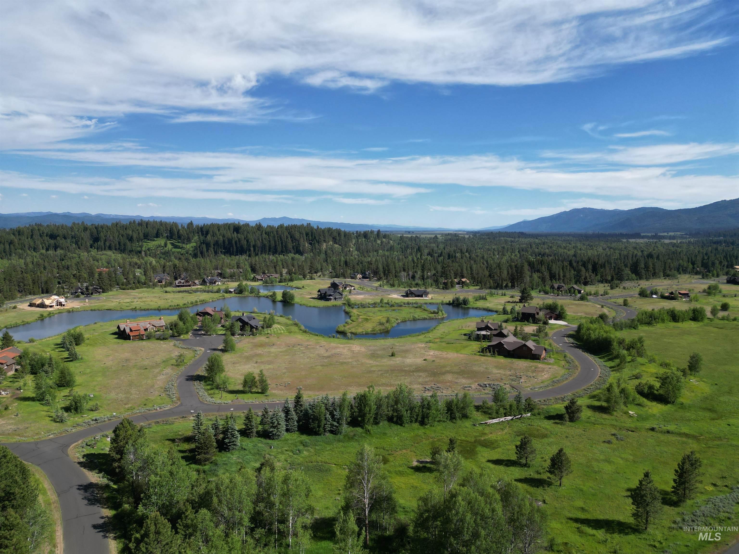 View of property location with a forest and a water and mountain view