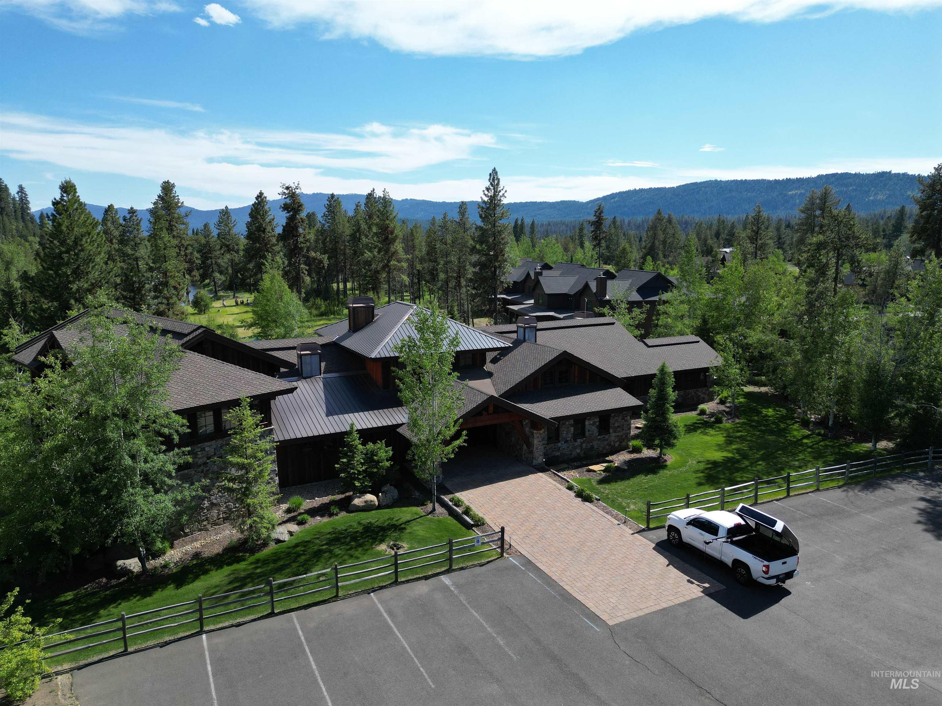 View from above of property with a heavily wooded area and mountains