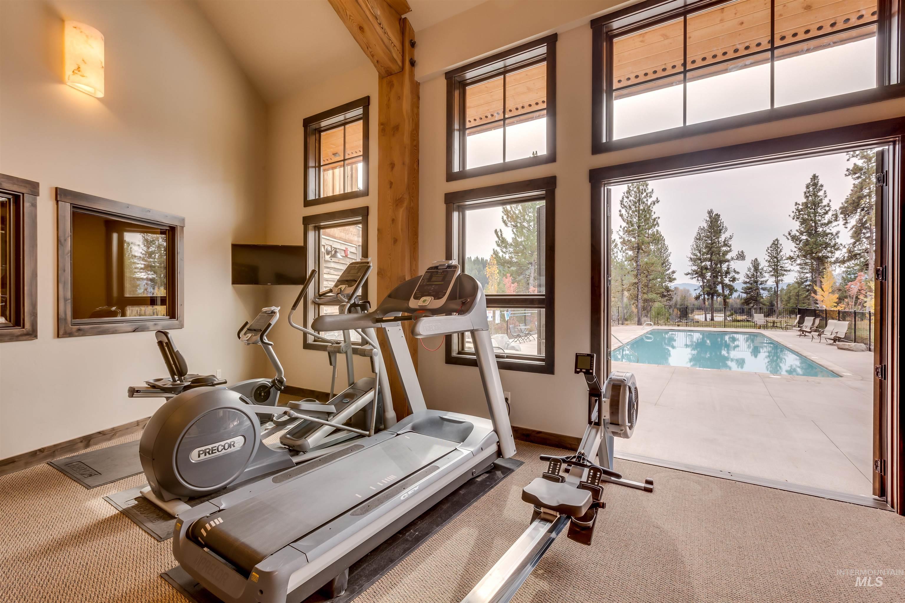Workout room with lofted ceiling