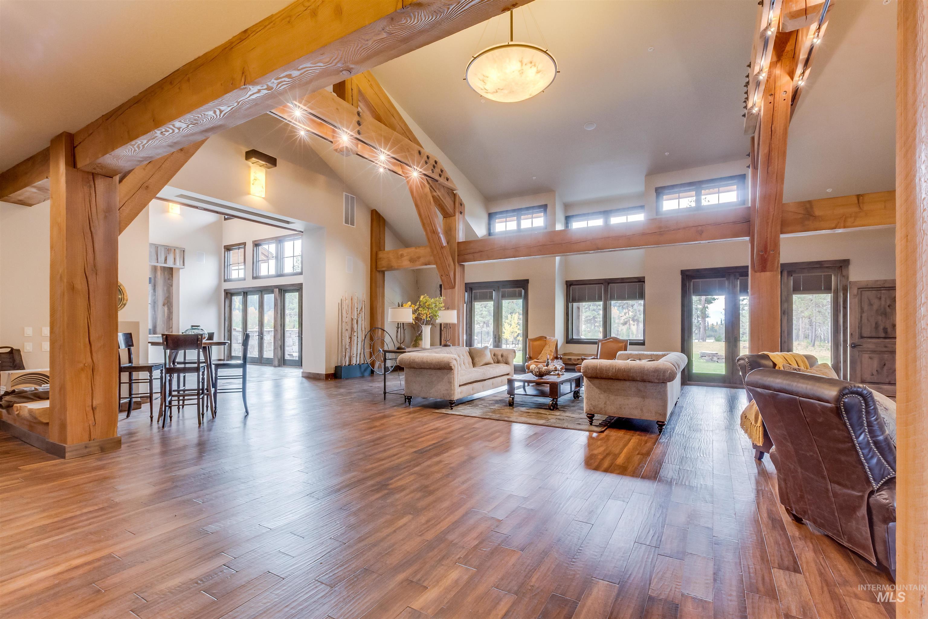Living room with a high ceiling and hardwood / wood-style floors