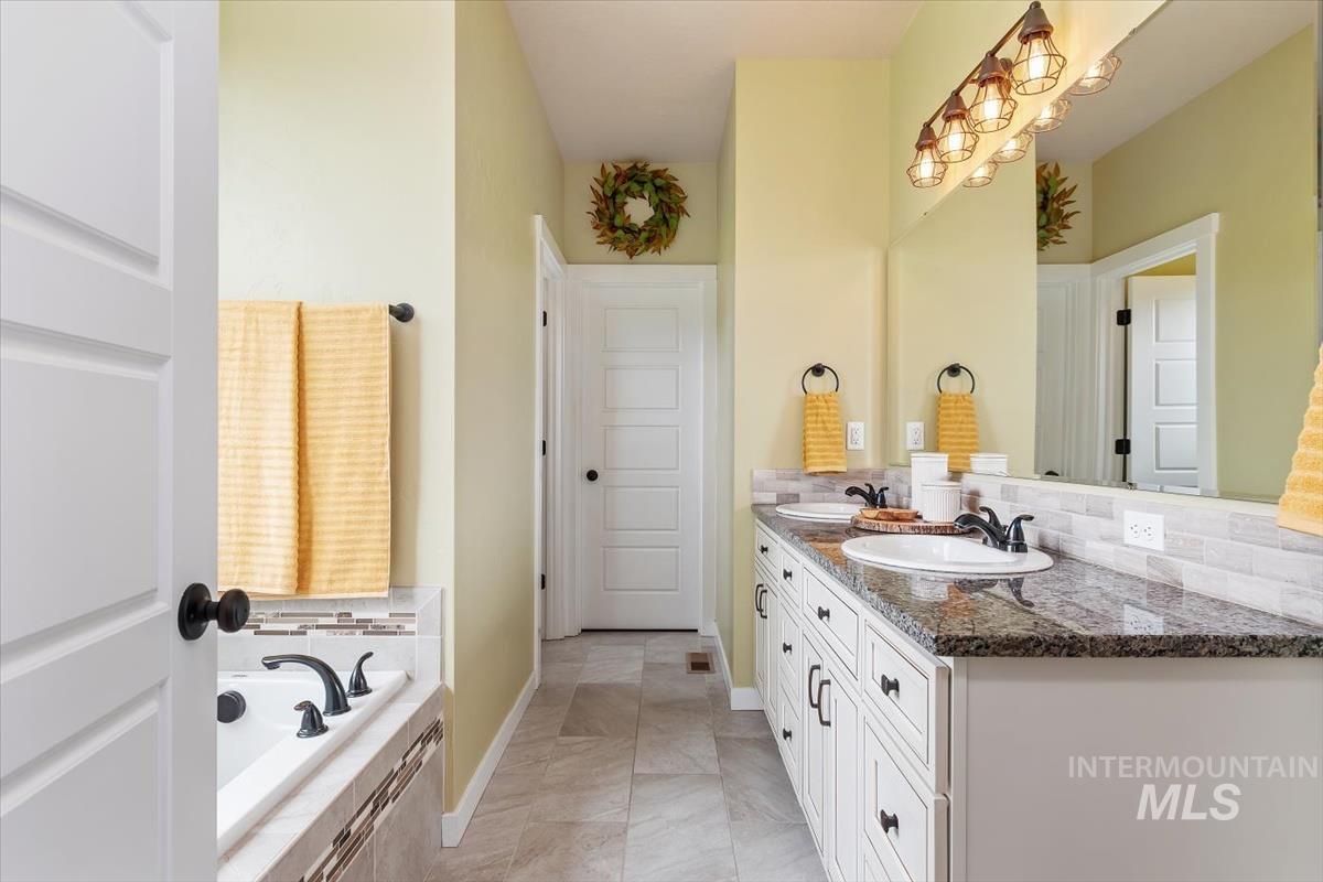 Full bath with double vanity and a bath