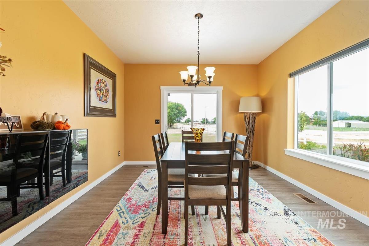 Dining space featuring a chandelier and wood finished floors