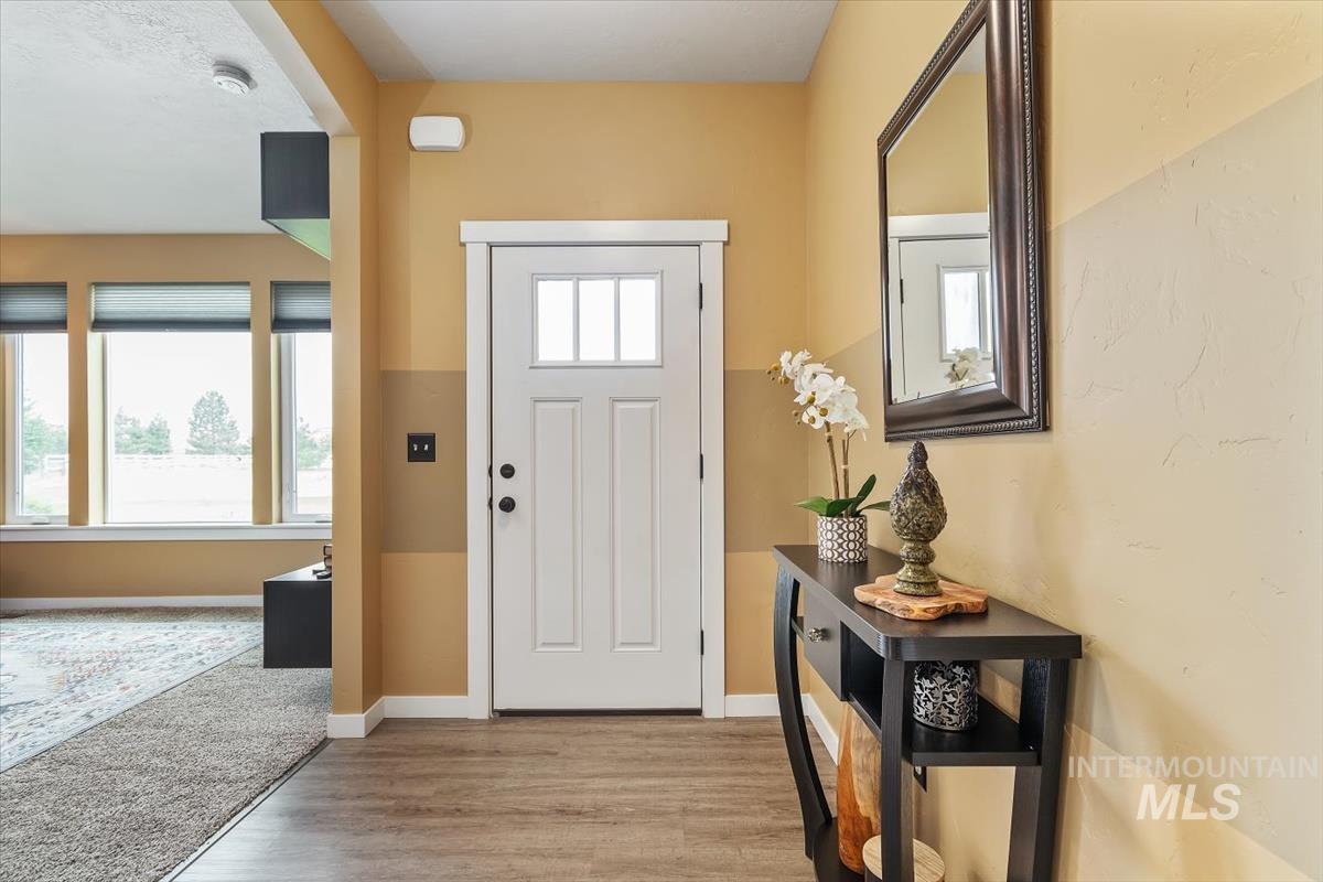 Entryway featuring wood finished floors and baseboards