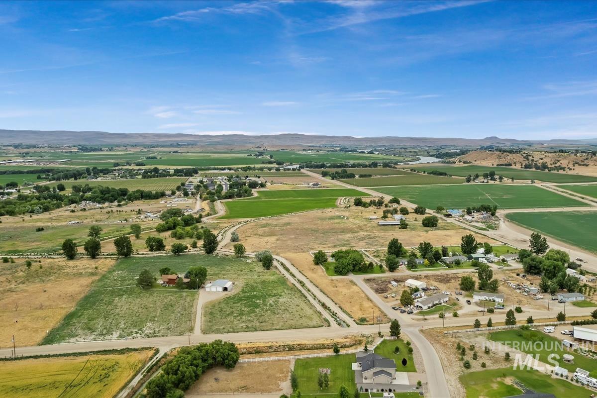 Aerial overview of property's location featuring rural landscape and a mountain backdrop