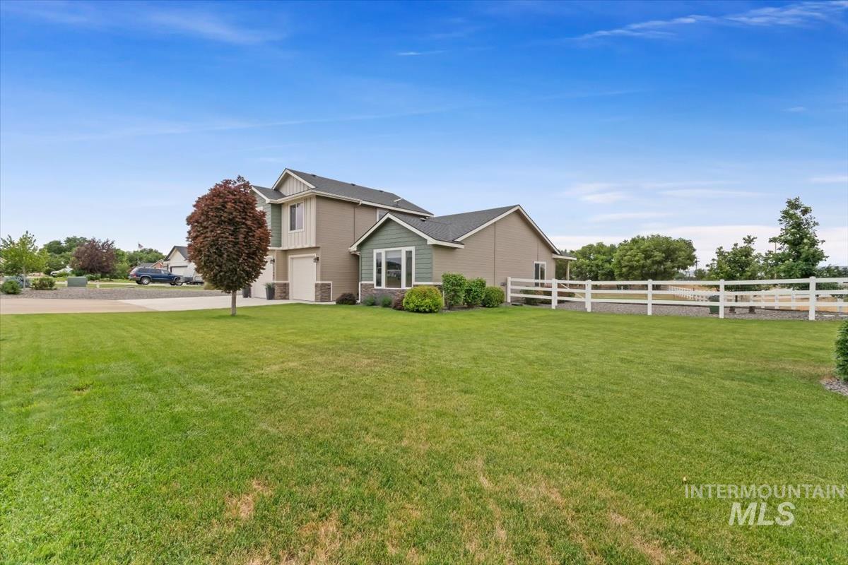 View of side of home featuring a garage and concrete driveway