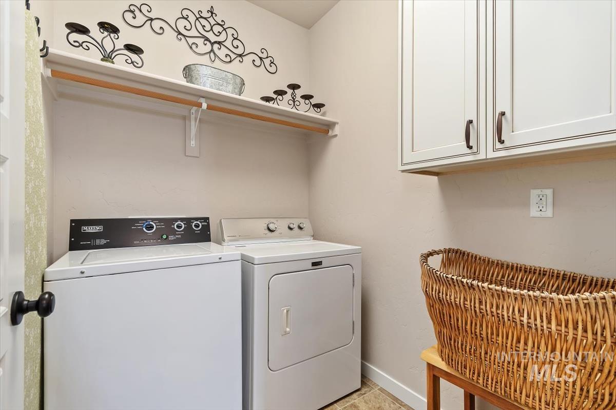 Laundry area with washer and clothes dryer and cabinet space