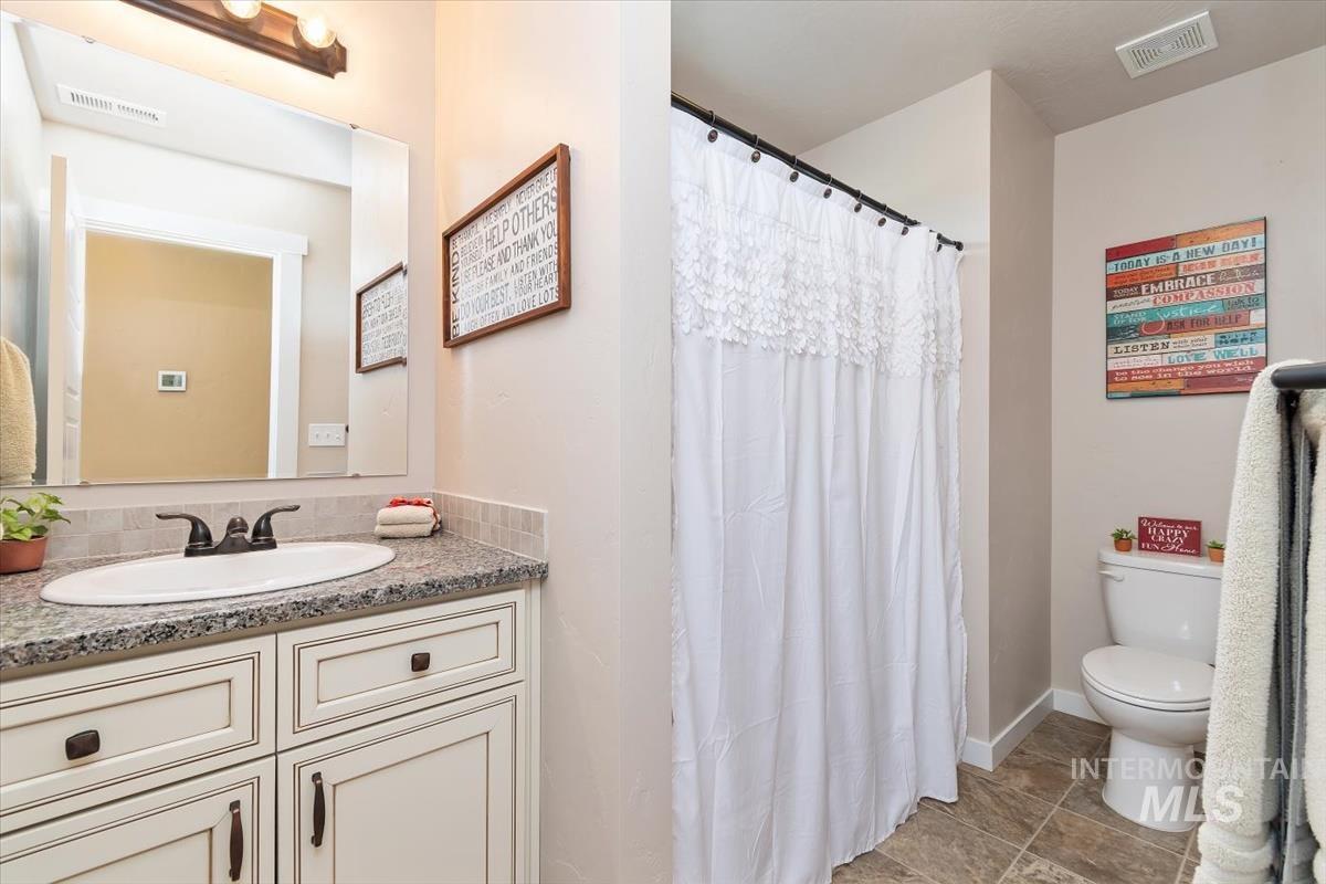 Full bathroom featuring vanity, a shower with curtain, and tile patterned floors