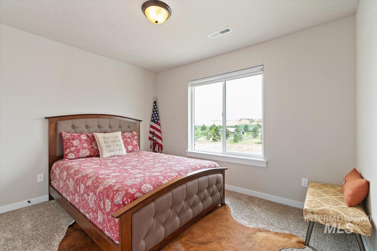 Carpeted bedroom featuring baseboards