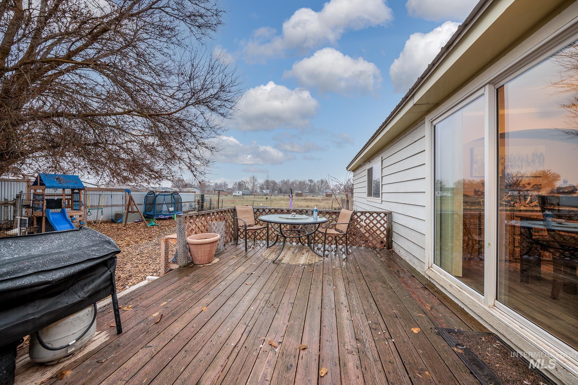 Deck with outdoor dining space and a playground