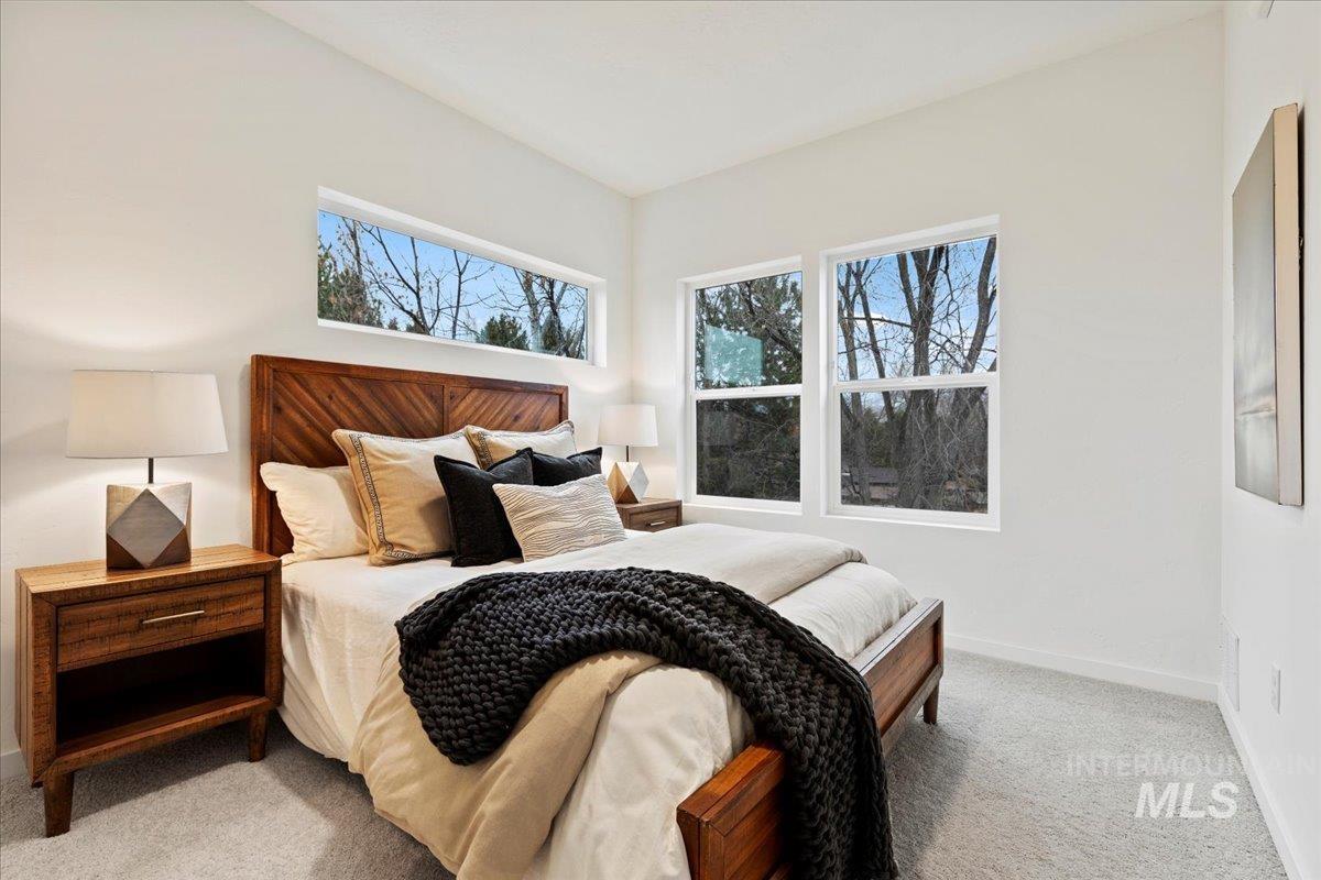 Bedroom with light carpet and baseboards