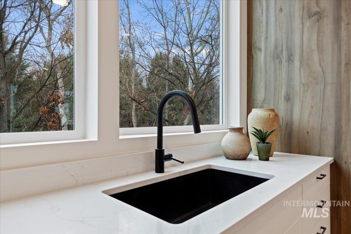 Kitchen view of light stone countertops and white cabinets