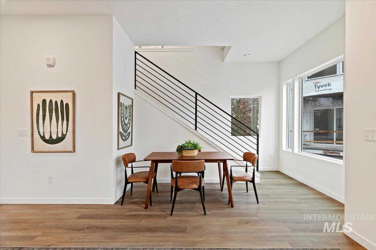 Dining space featuring light wood-style floors and stairs