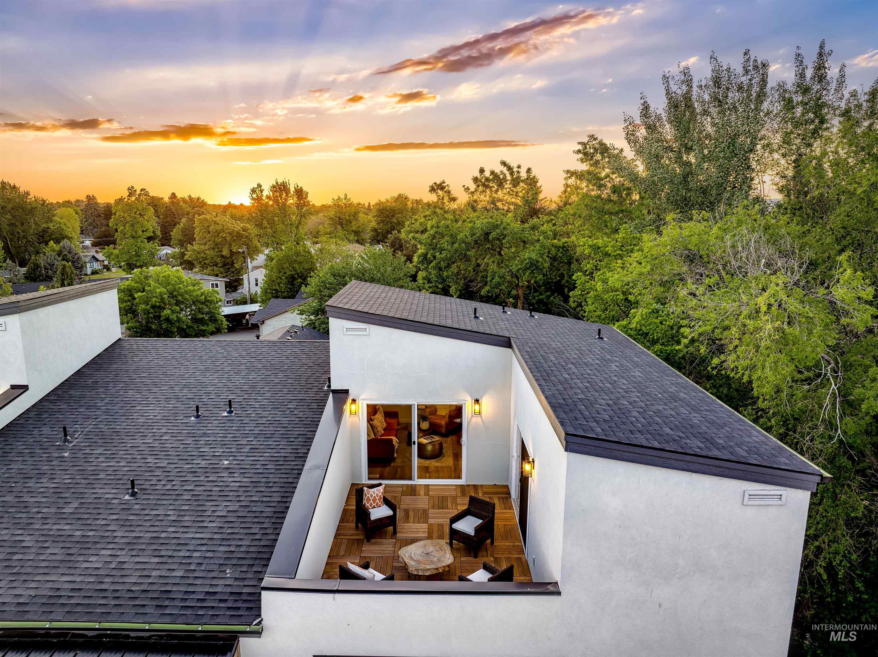 View of front of home with a shingled roof and stucco siding