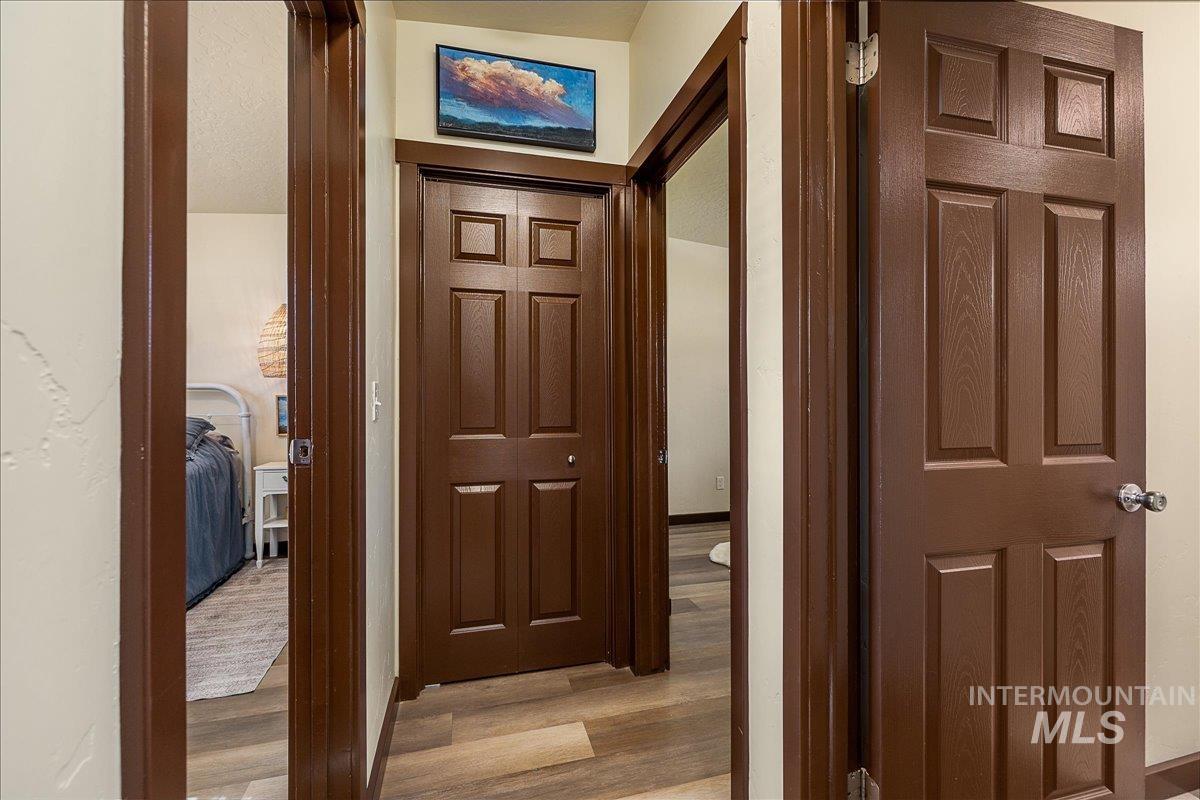 Corridor featuring light wood-style floors and baseboards